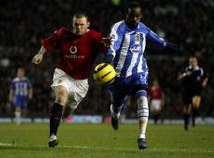 Manchester Uniteds Wayne Rooney (tv) var den store oplevelse i kampen mod Wigan, hvor han scorede to mål i 4-0-sejren. - Foto: AP 
