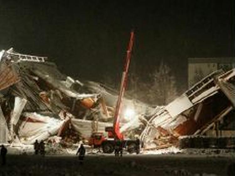 Myndighederne får hjælp fra en 20 ton tung kran, men redningsarbejdet er vanskeliggjort af fortsat snefald. - Foto: AP 