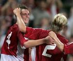 To af de dyreste danske spillere, Daniel Agger og Christian Poulsen, jubler efter Aggers mål i landsholdets 6-1-sejr over Georgien. Salget af danskere til udlandet gavner også fodbolden i Danmark. - Arkivfoto: Lars Poulsen 