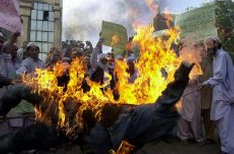 Vrede demonstranter brændte i går billeder af statsminister Anders Fogh Rasmussen af i Karachis gader i Pakistan. - Foto: AP 