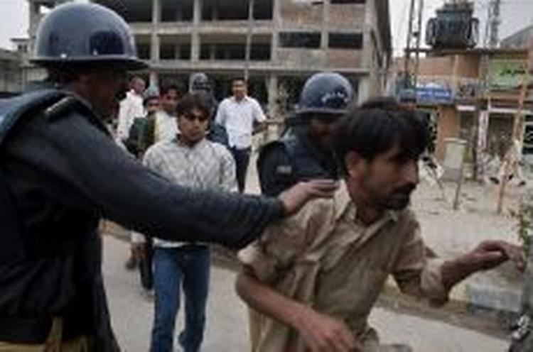 Politiet tilbageholder tilhængere af den islamiske alliance, Muttahide Majlis-i-Amal i byen Rawalpindi. - Foto: AP 