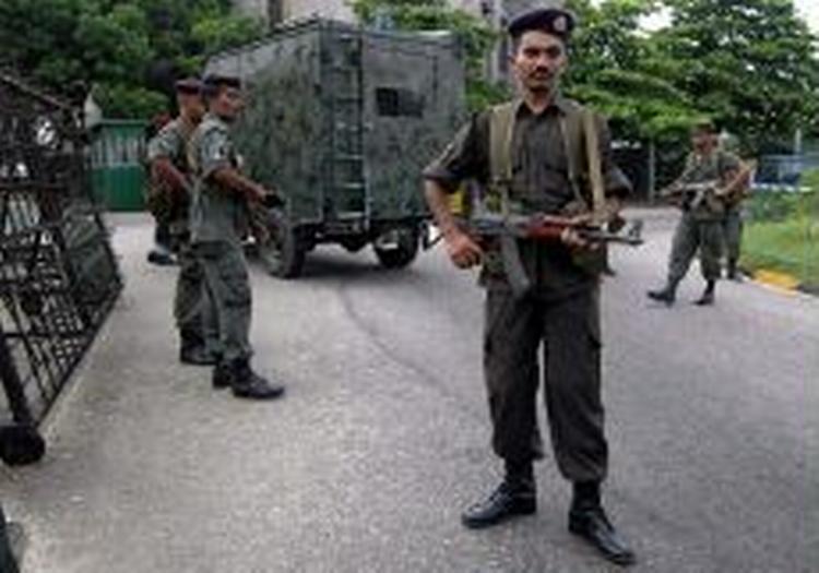 Sri lankanske soldater står vagt foran militærets hovedkvarter, hvor en selvmordsbomber - angiveligt fra den tamilske oprørshær - tirsdag spredte død og ødelæggelse. - Foto: AP 