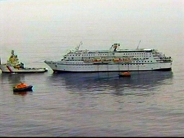 Krydstogtskibet 'Calypso' slæbes i havn efter branden på skibet. - Foto: AP 