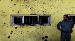 En politimand står ved et af de tre steder i Kabul, hvor bomber i dag blev rettet mod lokale busser. En blev dræbt og omkring 50 såret ved angrebene. - Foto: AP 