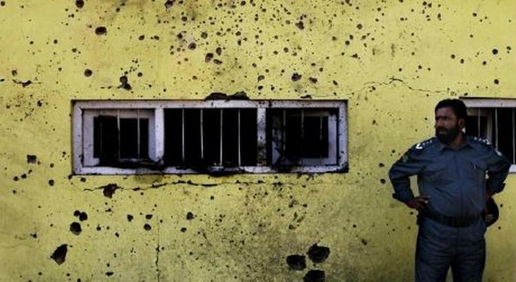 En politimand står ved et af de tre steder i Kabul, hvor bomber i dag blev rettet mod lokale busser. En blev dræbt og omkring 50 såret ved angrebene. - Foto: AP 