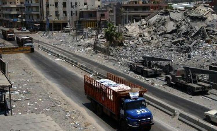 En lastbil med fødevarehjælp fra FN's organisation WFP passerer sønderskudte bygninger på vejen mellem Sidon og Tyre i det sydlige Libanon. Hizbollah beder nu om våbenhvile i konflikten med Israel. - Foto: AP 