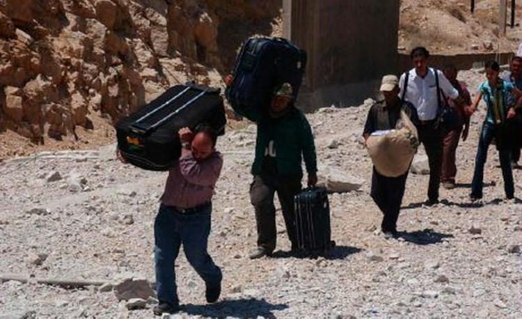 Libanesiske mænd samler deres ejendele, inden de flygter fra det sydlige Libanon. Iran og Syrien kan blive nøglen til en løsning på konflikten. - Foto: AP 