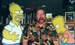 Skaberen af 'Simpsons', Matt Groening, ses her sammen med nogle af de fire-fingrede, gule personer fra den populære tegneserie. - Arkivfoto: AP 