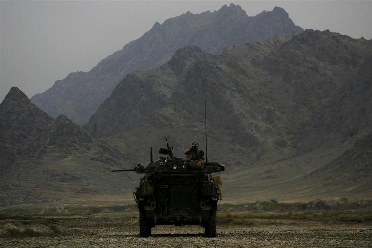 Foto af en canadisk soldat med kikkert på toppen af et pansret køretøj i Kandahar-provinsen. 