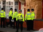 Politiet holder vagt uden for en af de 12 adresser i Birmingham, som i dag blev ransaget. 