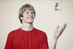 Teenager proud of new car, boy tossing car keys.