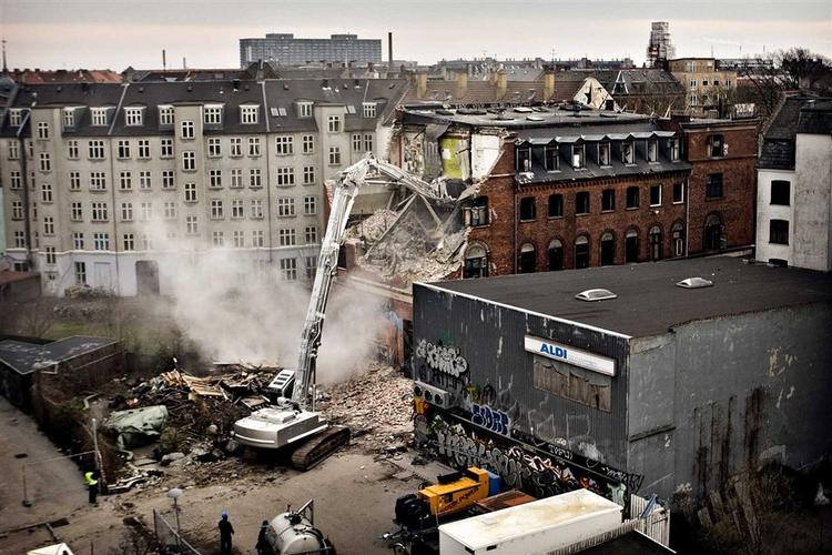 Miljøkontrollen har krævet, at der sprøjtes vand på støvet fra nedrivningen af Ungdomshuset på Jgtvej 69, før nedrivningen kan fortsætte. 