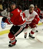 Detroit Red Wings Chris Chelios(i hvidt) har vundet en længere magtkamp mod NHL-spillerforeningens direktør, Ted Saskin. 
