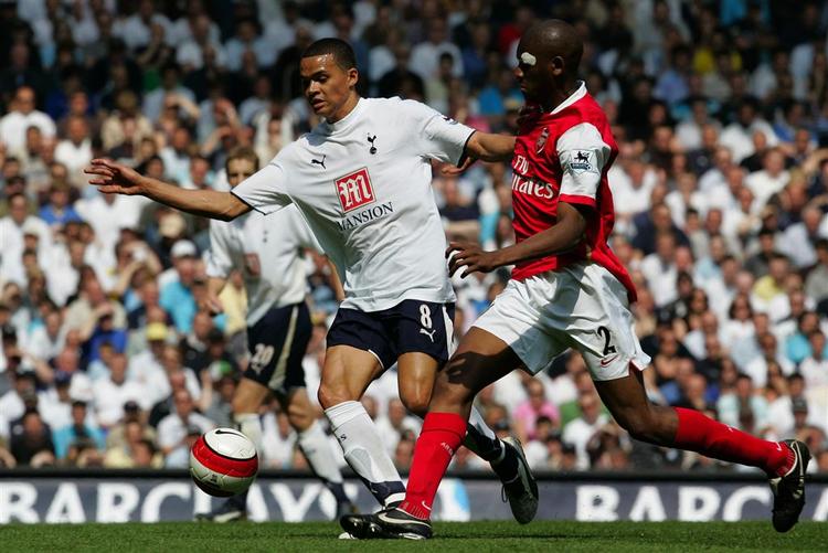 Jermaine Jenas, der i overtiden sikrede Spurs uafgjort, i kamp med Arsenals Abou Diaby. 