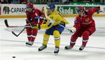 Det svenske ishockeylandshold måtte spille bronze-kamp uden nogle af deres mest hengivende fans, der ikke havde råd til de opskruede billetpriser. Her svenske Jonathan Hedström(i gult) i kamp med russerne Alexey Emelin og Sergey Brylin. 