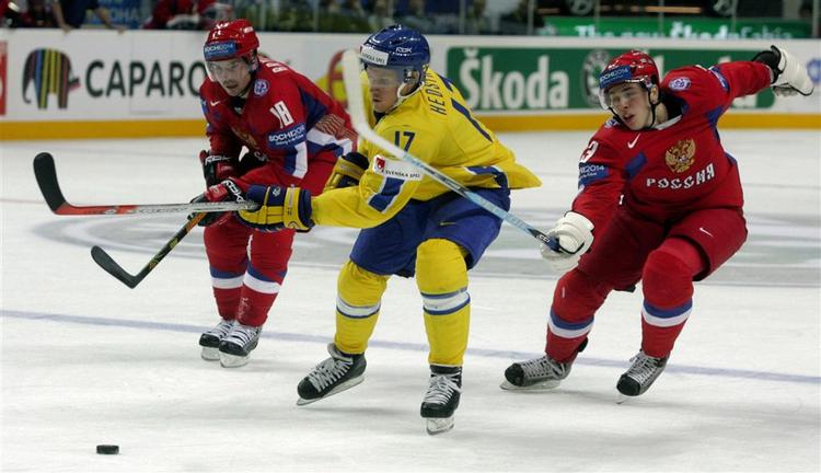 Det svenske ishockeylandshold måtte spille bronze-kamp uden nogle af deres mest hengivende fans, der ikke havde råd til de opskruede billetpriser. Her svenske Jonathan Hedström(i gult) i kamp med russerne Alexey Emelin og Sergey Brylin. 