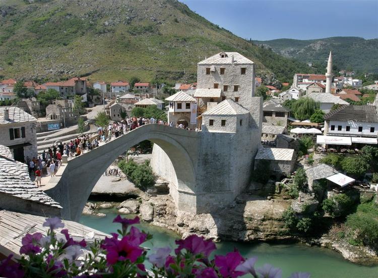 Byen Mostar er berømt for sin hvælvede bro og har figner, vindruer, tobak og granatæbler som symboler. Derfor pyntes restaurant Mostars kaffeislagskage med netop figner og granatæbler. 