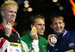 Sydafrikaneren Roland Schoeman og amerikaneren Ian Crocker (th.) var de eneste, der var hurtigere end Jakob Andkjær (tv.) i 50 meter butterfly ved VM i Melbourne i marts. 