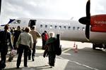 De første passagerfly går om bord på et fly af typen Dash 8 Q400 til Berlin 4. oktober, efter flyene har været groundet tre uger (arkivfoto). 