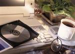 Laptop computer, CD-ROM, cup of tea, and glasses