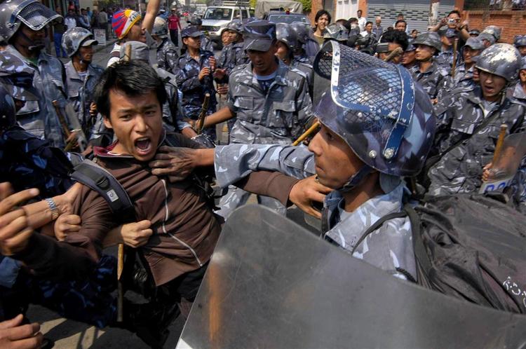 Protesterende tibetanere bliver fjernet foran en FN-bygning i Nepals hovedstad Katmandu. 