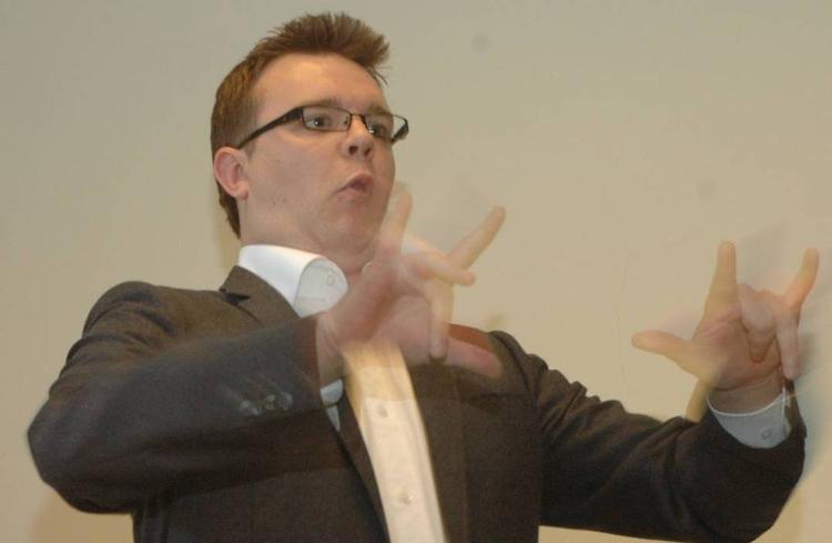 Lars Knudsen fra Danske Døves Landsforbund siger mundbevægelsen 'poh' til det tegn, han viser på billedet. Det betyder 'det lykkedes'. 