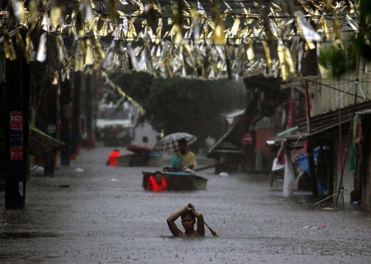 Gaderne stod under vand, da tyfonen Fengshen ramte Filippinernes hovedstad, Manila. Nu har stormen ramt Kina og dræbt ni personer. 