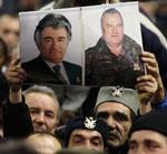Den ene er fanget, den anden på fri fod. Serbiske nationalister frembærer portrætter af deres helte Karadzic og Mladic forud for det serbiske præsidentvalg den 20. januar. Valget endte med et mere EU-venligt styre. 