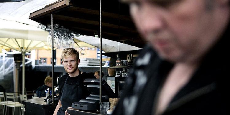 Sommerassistenten er glad for regnen. Med færre gæster er det noget nemmere at overskue tjansen som tjener på Christianshavns Bådudlejning. Foto: Sara Galbiati 