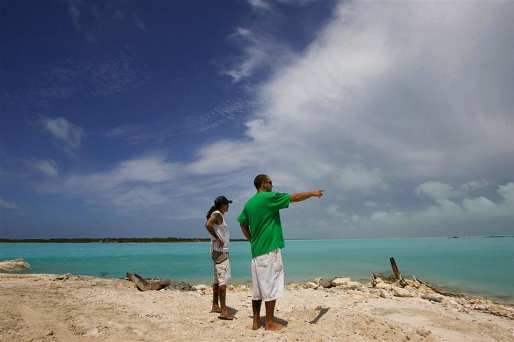 Strandgæster betragter de første skyer fra Ike på de caribiske øer Providenciales. 