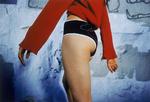 A close up of a girl in black rhinestone shorts and a red sweats