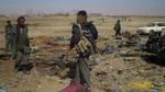 Afghanske politifolk på stedet hvor en selvmordsbombe dræbte 80 mennesker ved Kandahar.PET vurderer, at der sendes penge fra Danmark til terrorgrupper i bl.a Afghanistan. 