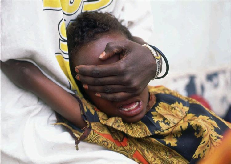 Archive photo: Hudan Mohammed Ali, 6, screams in pain while undergoing circumcision in Hargeisa, Somalia, June 17, 1996. Her sister Farhyia Mohammed Ali, 18, holds her so she cannot move. 