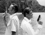 Til venstre Christopher Lee med den gyldne pistol, og til højre James Bond i skikkelse af Roger Moore. 