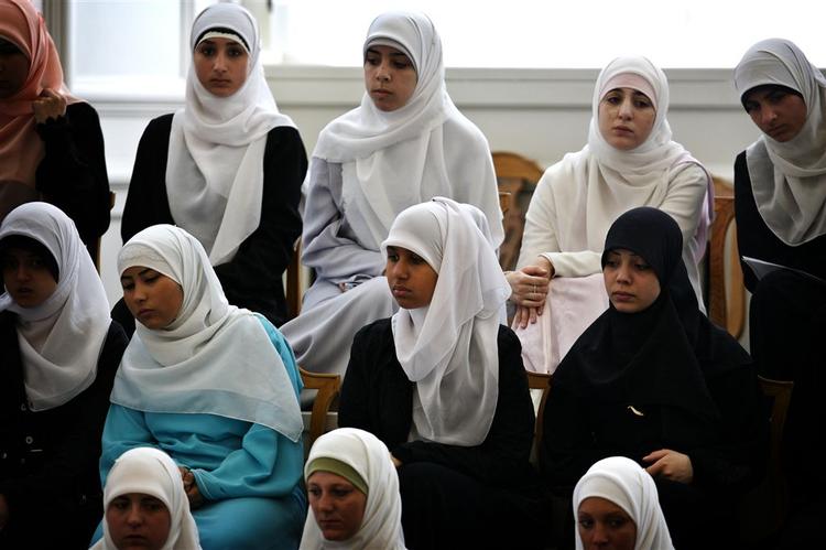 Muslimske kvinder følger en folketingsdebat om tørklæder. 