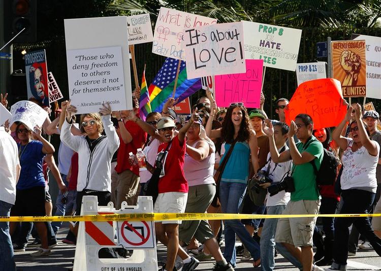 Demonstranter viser deres bannere i Los Angeles lørdag. De er stærkt utilfredse med, at homoægteskaber er blevet ulovlige som følge af en lokal afstemning i forbindelse med præsidentvalget. 