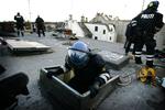 Politiet på vej ned ad loftslemmen på Ungdomshuset under rydningen 1. marts 2007. 