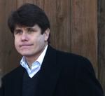 Rod Blagojevich på vej på arbejde, som om intet er hændt. Kommentatorer vurderer, at han fortsætter på arbejde, fordi det ellers kan virke som en tilståelse. 