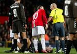 Manchester Uniteds Wayne Rooney bedyrer sin uskyld over for dommer Duhamel Laurent efter sin tackling mod AaB's Kasper Risgård under Champions League-kampen i sidste uge. 