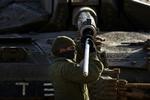 En israelsk soldat på arbejde  ved Gazastriben efter det luftangreb, der har dræbt mindst 280 palæstinensere. 