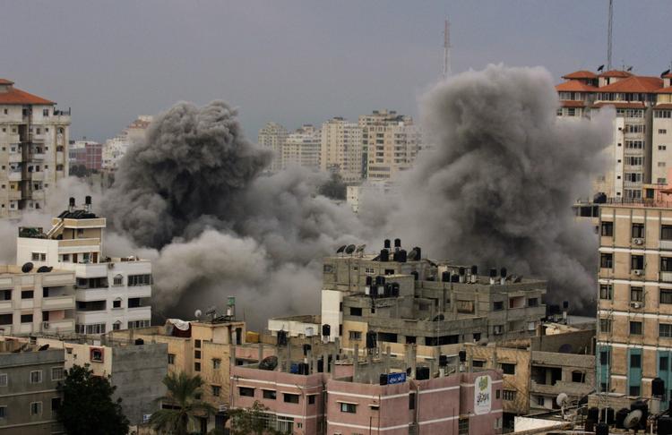A pall of smoke rises after an explosion from an Israeli missile strike on the Hamas controlled Islamic University in Gaza City. 