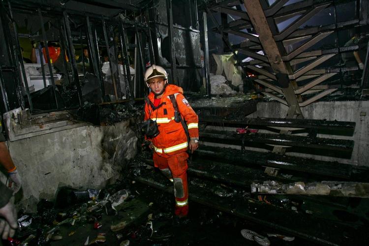 Brandmand undersøger den udbrændte natklub i Bangkok. 