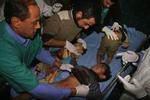 Palæstinensiske hospitalsfolk tilser sårede børn i Gaza By mandag. 