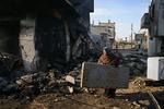 En palæstinensisk kvinde har fundet en madras i resterne af en udbombet bygning i Rafah. I området boede flere Hamas-ledere, hvis huse er blevet totalt ødelagt. 