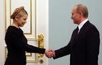 Den russiske premierminister Vladimir Putin giver hånd til Julia Timoshenko i dag i Moskva. 