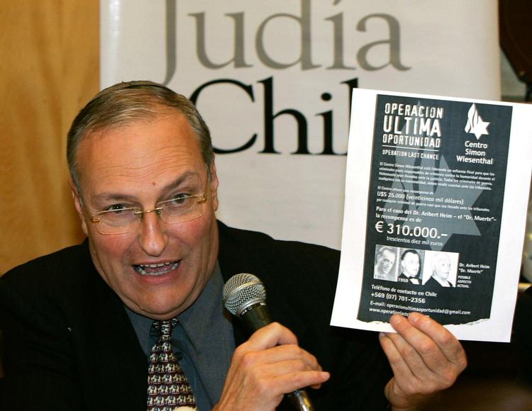 Efraim Zuroff, director of the Jewish Simon Wiesenthal Center, holding up a reward sign during a press conference in Santiago in July 2008. Representatives of the Jewish human rights organization arrived in Chile in a renewed hunt for former SS doctor Aribert Heim. . 