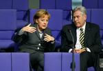 German Chancellor Angela Merkel speaks to German Economy Minister Michael Glos who has now resigned. The chaotic handling of his resignation has prompted criticism of Chancellor Angela Merkel. Archive photo. 