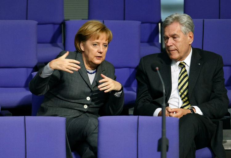 German Chancellor Angela Merkel speaks to German Economy Minister Michael Glos who has now resigned. The chaotic handling of his resignation has prompted criticism of Chancellor Angela Merkel. Archive photo. 
