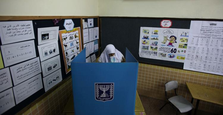En israelsk kvinde, med arabisk baggrund, afleverer sin stemme ved et valgsted i den arabiske landsby Umm Al-Fahm i Israel. 