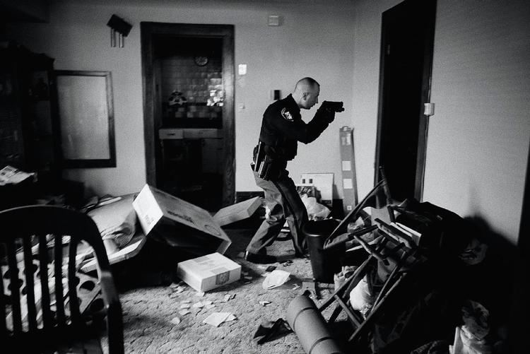 Betjent Robert Kole sikrer sig, at beboerne i et hjem i Cleveland i staten Ohio har fraflyttet adressen. Fotoet er taget 26. marts sidste år. 
